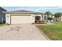 Paved driveway leading to a two-car garage, enhanced with a decorative star pattern at 2746 Windsorgate Ln, Orlando, FL 32828