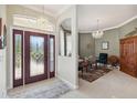 Home foyer featuring tile flooring, chandelier, and decorative glass front door at 2746 Windsorgate Ln, Orlando, FL 32828