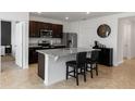 Bright, modern kitchen featuring granite countertops, stainless steel appliances, and dark wood cabinetry at 296 Inman Blvd, Winter Haven, FL 33881