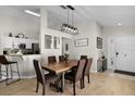 The dining room features modern lighting, wood flooring, and neutral walls at 339 Holborn Loop, Davenport, FL 33897