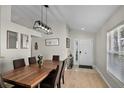 The dining room features modern lighting, wood flooring, and neutral walls at 339 Holborn Loop, Davenport, FL 33897