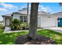 Charming single-story home with a well-manicured lawn and a two car garage at 339 Holborn Loop, Davenport, FL 33897