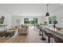 Open floor plan with living, dining, and kitchen areas filled with natural light from large windows at 3650 Grant Blvd, Orlando, FL 32804
