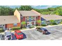 View of the building shows colorful townhomes and a parking area at 4952 Tangerine Ave # 4952, Winter Park, FL 32792