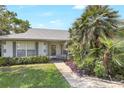 Inviting home entrance features a landscaped walkway and charming seating at 5382 Sw 84Th Pl, Ocala, FL 34476