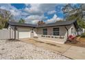 Charming single-story home with a manicured lawn, flower bed, and an attached one-car garage at 540 Diane Cir, Casselberry, FL 32707