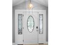 Elegant front door with decorative glass, complemented by sidelights and a modern locking system at 5671 Cypress Gardens Rd, Winter Haven, FL 33884