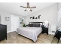 Bright bedroom with a neutral color scheme, ceiling fan, and wood-look tile flooring at 7616 Simms Ave, Orlando, FL 32812