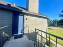 Condo entrance featuring a blue door, stairs, and railing, providing a welcoming approach to the home at 936 Birmingham Ct # 200, Lake Mary, FL 32746
