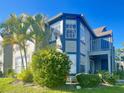 Two-story condo featuring blue and beige siding, a balcony, and lush landscaping, offering a charming curb appeal at 936 Birmingham Ct # 200, Lake Mary, FL 32746