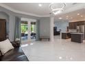 Spacious living room featuring modern lighting and an open floor plan, great for entertaining at 9780 Cypress Pine St, Orlando, FL 32827