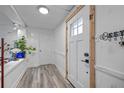 Welcoming entryway features new laminate flooring, fresh paint, and a stylish front door with window at 985 N Village Dr, Deltona, FL 32725