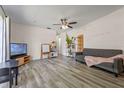 Spacious living room featuring new flooring, a ceiling fan, and plenty of natural light at 985 N Village Dr, Deltona, FL 32725