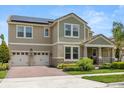 Beautiful two-story home with a two-car garage, solar panels, well-kept lawn and a brick-paved driveway at 9873 Lost Creek Dr, Winter Garden, FL 34787