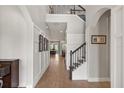 Elegant foyer featuring wood floors, staircase with iron railings, and soaring ceilings for a grand entrance at 9873 Lost Creek Dr, Winter Garden, FL 34787