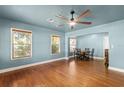 Spacious living room with hardwood floors, ceiling fan, and an adjacent dining area at 1003 S Center St, Eustis, FL 32726