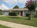 Charming single-story home with a well-maintained front yard and a two-car garage at 10208 Brownwood Ave, Orlando, FL 32825