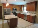 Well-lit kitchen features stainless steel appliances, granite countertops, and an island at 10208 Brownwood Ave, Orlando, FL 32825