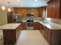 Updated kitchen with stainless steel appliances, granite countertops and breakfast bar at 10208 Brownwood Ave, Orlando, FL 32825