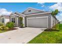Attractive single-Gathering home with a two-car garage, landscaped garden beds, and a well-kept lawn at 1120 Mattie Pointe Blvd, Auburndale, FL 33823