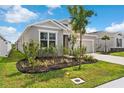 Landscaped front yard with vibrant plantings accentuates this lovely single-Gathering home at 1120 Mattie Pointe Blvd, Auburndale, FL 33823