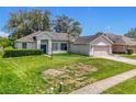 Charming single Gathering home features a manicured lawn and attached two-car garage at 1131 Turtle Lake Ct, Ocoee, FL 34761