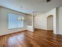 Open-concept living area with hardwood floors, bright windows and chandelier at 1131 Turtle Lake Ct, Ocoee, FL 34761