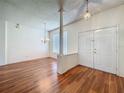 Bright living room with gleaming hardwood floors and elegant lighting fixtures at 1131 Turtle Lake Ct, Ocoee, FL 34761