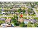 Birds eye view of neighborhood with mature trees, swimming pools, and well-maintained lawns at 1135 Plato Ave, Orlando, FL 32809