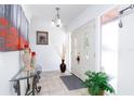 Bright foyer with double doors, tiled floors, and elegant décor, creating a welcoming entrance at 1135 Plato Ave, Orlando, FL 32809