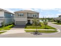 Beautiful two-story home showcasing a manicured lawn, landscaping, and a two car garage at 13822 Destin Beach Ln, Orlando, FL 32827