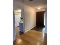 Inviting entryway showcasing wood and tile flooring, leading into an open-concept kitchen at 1484 Magellan Cir # 403, Orlando, FL 32818