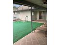 Beautiful patio with synthetic grass, chaise lounges, and fan at 1484 Magellan Cir # 403, Orlando, FL 32818