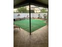 Beautiful screened patio with tile flooring and synthetic grass for a maintenance free yard at 1484 Magellan Cir # 403, Orlando, FL 32818