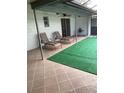Beautiful patio featuring chaise lounges, synthetic grass, and a ceiling fan at 1484 Magellan Cir # 403, Orlando, FL 32818