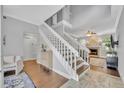 Bright foyer with staircase, wood floors, and open view into the living area at 1576 Crosswind Cir, Orlando, FL 32825