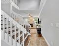 Bright entryway with a white staircase leading to the upper level and a glimpse into the living area at 1576 Crosswind Cir, Orlando, FL 32825
