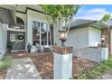 Inviting front porch with mature landscaping and walkway at 1745 Seneca Blvd, Winter Springs, FL 32708