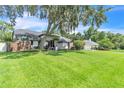 Charming home features a spacious front yard, stucco exterior, and mature landscaping at 1745 Seneca Blvd, Winter Springs, FL 32708