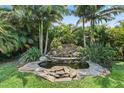 Lush backyard oasis with stone waterfall and tropical landscaping at 2325 Bella Luna Cir, Lakeland, FL 33810