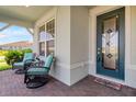 Inviting front porch with comfortable seating, brick flooring, and decorative front door at 2793 Nature View Rd, St Cloud, FL 34771