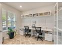 Bright home office featuring dual workstations, stylish decor, and natural light at 2793 Nature View Rd, St Cloud, FL 34771