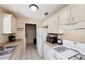 Functional kitchen with white cabinets, appliances, and durable countertops at 2822 Fulford St, Deltona, FL 32738