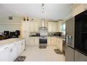 Bright kitchen with stainless steel appliances, white cabinetry, and light countertops at 3600 Fountainbleu Blvd, Kissimmee, FL 34746