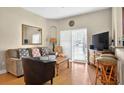 Inviting living room with hardwood floors, seating, and sliding glass doors for natural light at 3725 Calabria Ave, Davenport, FL 33897