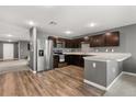 Modern kitchen with stainless steel appliances, dark wood cabinets, and a breakfast bar at 391 Begonia Ct, Kissimmee, FL 34759