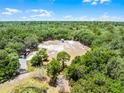 Wide aerial shot displaying a spacious property with multiple buildings, trees, and open areas at 4055 State Road 11, Deland, FL 32724