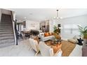 Open-concept living area features a modern design, stylish furnishings, and easy access to the kitchen at 4184 Paragraph Dr, Kissimmee, FL 34746