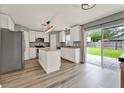 Bright kitchen with stainless steel appliances, center island, and sliding door access to the backyard at 4756 Fiske Cir, Orlando, FL 32826
