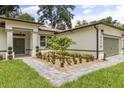 Up close view of the home with manicured landscaping, brick pavers, and a charming exterior at 4770 Drummond Ln, Orlando, FL 32810